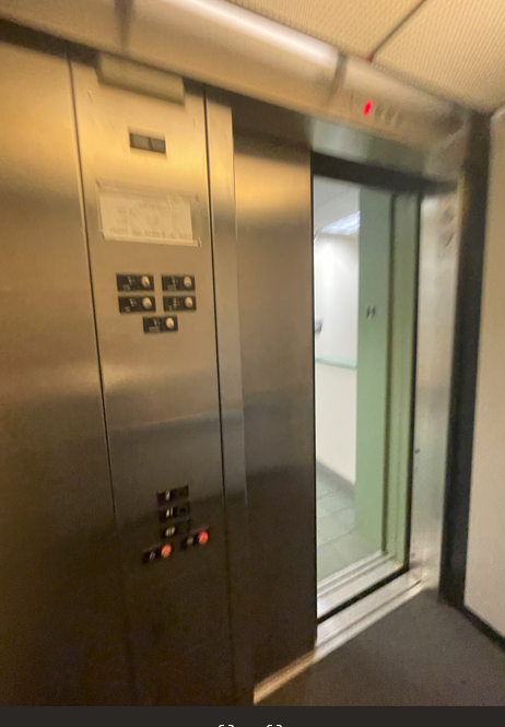 The image shows a wall-mounted elevator control panel inside an elevator shaft.AI-generated content may be incorrect.